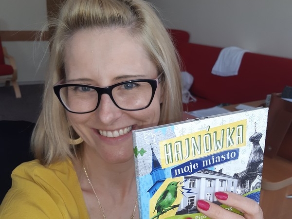 Uśmiechnięta Marta Gredel-Iwaniuk prezentuje płytę CD o tytule "Hajnówka moje miasto"