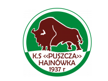 Logo KS Puszcza Hajnówka Logo w kształcie biało – zielonego koła. W centralnym miejscu narysowany brązowy żubr, pod nim na białym tle brązowy napis: K.S. <<Puszcza>> Hajnówka 1937r. 