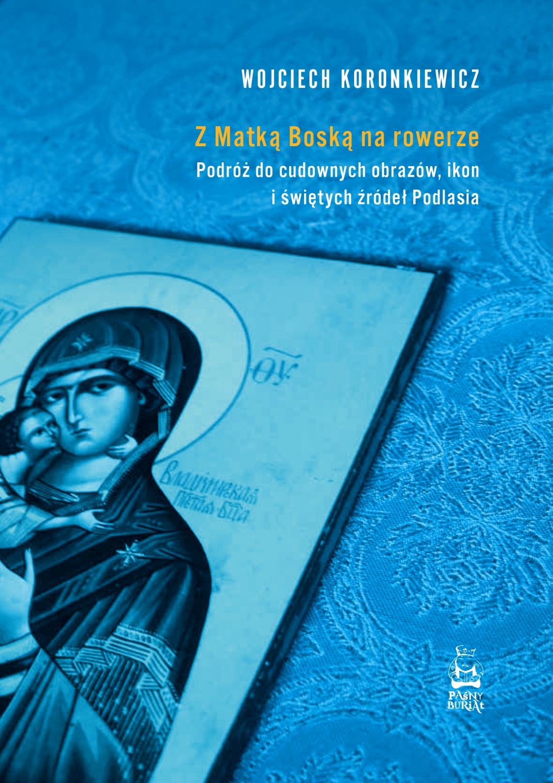 niebieska okładka książki; z lewego rogu wyłania się ikona Dogurodzicy, w prawym górnym rogu tytuł książki Wojciech Koronkiewicz "Z Matką Boską na rowerze"