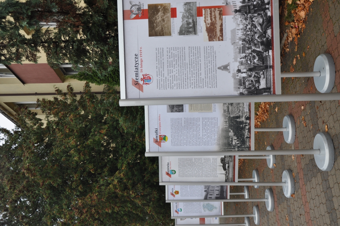 rząd plansz ustawionych przed budynkiem urzędu