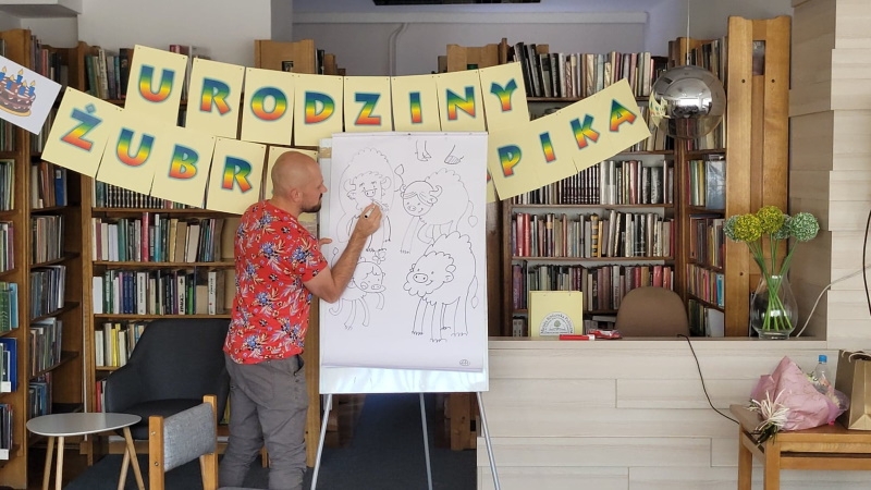 Tomasz Samojlik rysuje rodzinę Żubra Pompika.