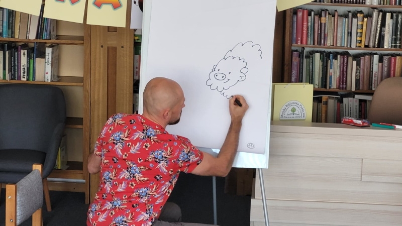 Tomasz Samojlik rysuje rodzinę Żubra Pompika.