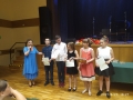 dzieci otrzymują dyplomy z okazji ukończenia roku szkolnego
