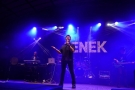 mężczyzna na scenie. W tle widać napis ZENEK